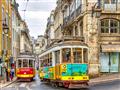 Dve farebné električky v uliciach Lisabonu.